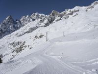 skiers make their way down a slope in the snow near some mountains on the side