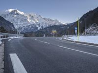 a paved road and mountain in the background with a sky scraper in front of it