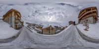 a spherical photo of an outside view with snow everywhere and a few buildings with bales of snow