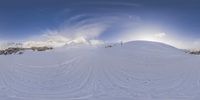 two people on skis are going uphill in the snow and in the air