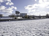 Frozen Lake with Building in Snowy Landscape