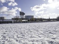 Frozen Lake with Building in Snowy Landscape