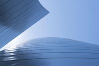 buildings that are shaped to look like they are flying through the air with blue sky background