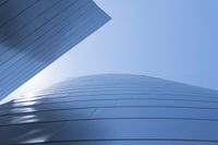 buildings that are shaped to look like they are flying through the air with blue sky background