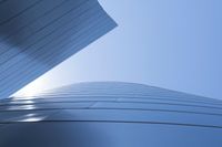 buildings that are shaped to look like they are flying through the air with blue sky background