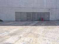 an empty room with a red suitcase in it on the ground in front of a garage