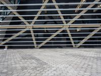 a building with some metal bars and bricks flooring on the outside of it in sunlight