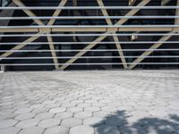 a building with some metal bars and bricks flooring on the outside of it in sunlight