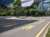 the sidewalk is wide and empty in a city setting with a sky background, there are trees, buildings, a traffic light and a blue sky