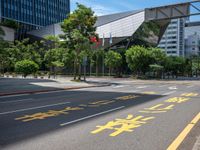 the sidewalk is wide and empty in a city setting with a sky background, there are trees, buildings, a traffic light and a blue sky