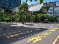 the sidewalk is wide and empty in a city setting with a sky background, there are trees, buildings, a traffic light and a blue sky