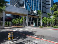 there is a yellow and black fire hydrant on the street in front of tall buildings