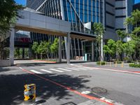 there is a yellow and black fire hydrant on the street in front of tall buildings