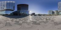 an image of some buildings taken from a fish - eye lens camera in the city