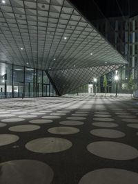 the floor has large circular tiles on it as well as a roof above a building