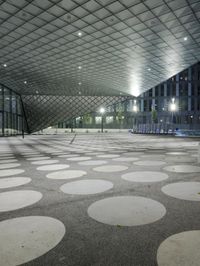 the floor has large circular tiles on it as well as a roof above a building