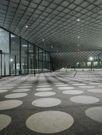 the floor has large circular tiles on it as well as a roof above a building