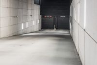 the large concrete wall has been illuminated by recessed lights at night on either side of it