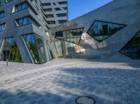 the entrance of the building has triangles that are shaped like intersecting, one at which appears to be being very interesting