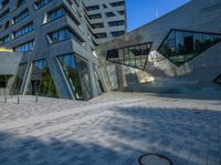 the entrance of the building has triangles that are shaped like intersecting, one at which appears to be being very interesting