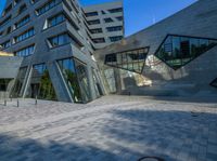 the entrance of the building has triangles that are shaped like intersecting, one at which appears to be being very interesting