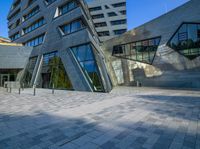 the entrance of the building has triangles that are shaped like intersecting, one at which appears to be being very interesting