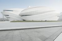 there is a large white building with curved panels on it's sides that looks like a fish