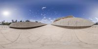 a fish eye lens showing a couple skateboards and half a half dome shaped like an alien creature