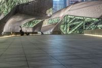 an abstract image of an outside building with large windows and floor to ceiling lighting of a modern architecture