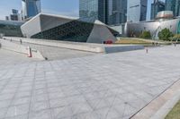 a skateboarder rides down a walkway in a city setting with many skyscrapers