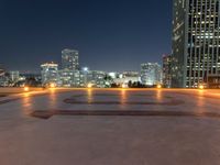 the large clock is in the middle of the empty square with skyscrapers in the background