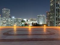 the large clock is in the middle of the empty square with skyscrapers in the background