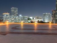 the large clock is in the middle of the empty square with skyscrapers in the background