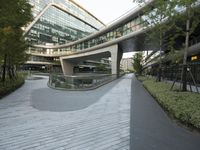 there is a curved, modern building along the sidewalk in the city area that looks like it has been designed to mimic traffic and landscape