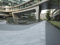 there is a curved, modern building along the sidewalk in the city area that looks like it has been designed to mimic traffic and landscape