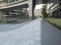 there is a curved, modern building along the sidewalk in the city area that looks like it has been designed to mimic traffic and landscape