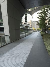 there is a curved, modern building along the sidewalk in the city area that looks like it has been designed to mimic traffic and landscape
