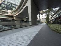 there is a curved, modern building along the sidewalk in the city area that looks like it has been designed to mimic traffic and landscape