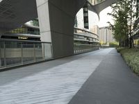 there is a curved, modern building along the sidewalk in the city area that looks like it has been designed to mimic traffic and landscape