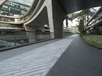 there is a curved, modern building along the sidewalk in the city area that looks like it has been designed to mimic traffic and landscape