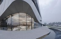 a large glass building that is designed like an unusual structure in china, with a circular entrance in front