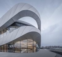 a large glass building that is designed like an unusual structure in china, with a circular entrance in front