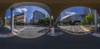 the 360 viewing lens has the image of an open parking lot on it and two buildings and a sky background