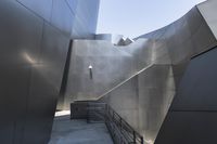 the building is made out of aluminium with light on it's roof and a handrail in the middle