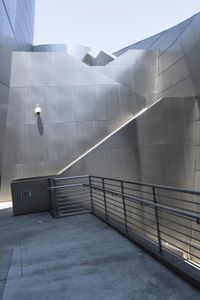 the building is made out of aluminium with light on it's roof and a handrail in the middle