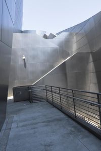 the building is made out of aluminium with light on it's roof and a handrail in the middle