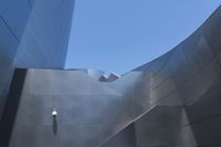 the building is made out of aluminium with light on it's roof and a handrail in the middle