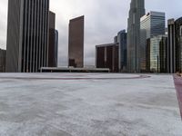 skyscrapers in the middle of a city near a sidewalk with a red marker pointing to them