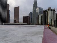 skyscrapers in the middle of a city near a sidewalk with a red marker pointing to them