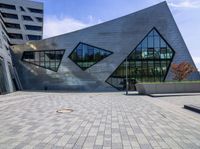 a modern building with a stone facade that looks like an triangleshed building on the outside